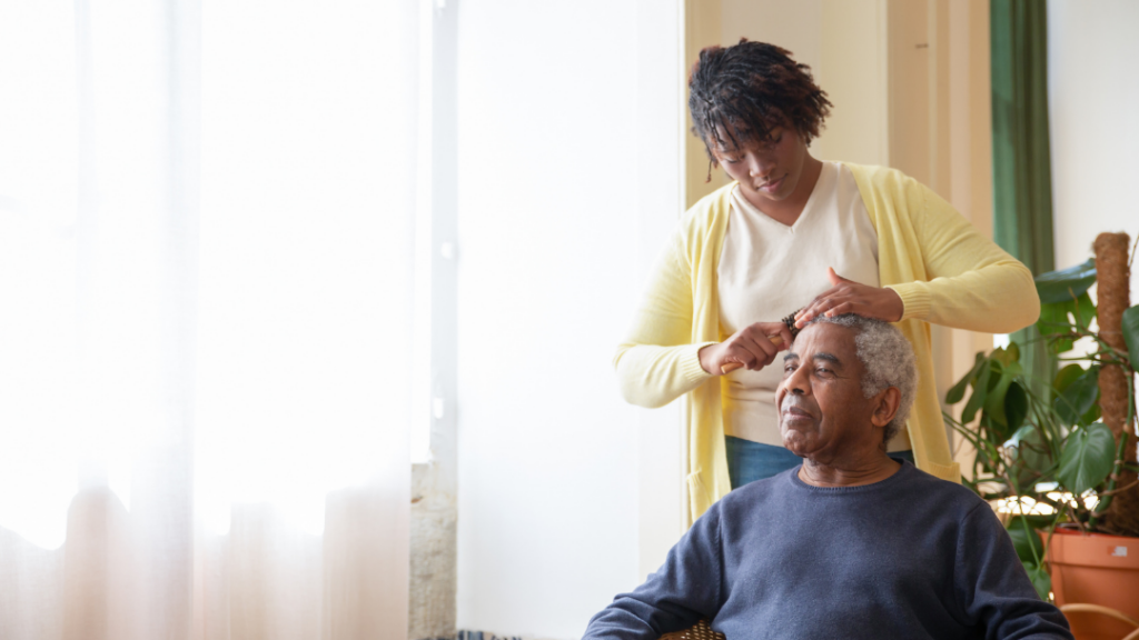 Caring for Someone with a Chronic Illness: How to Support Without Burning Out - Caregiver styling an elderly man's hair as he sits calmly in a sunlit room.
