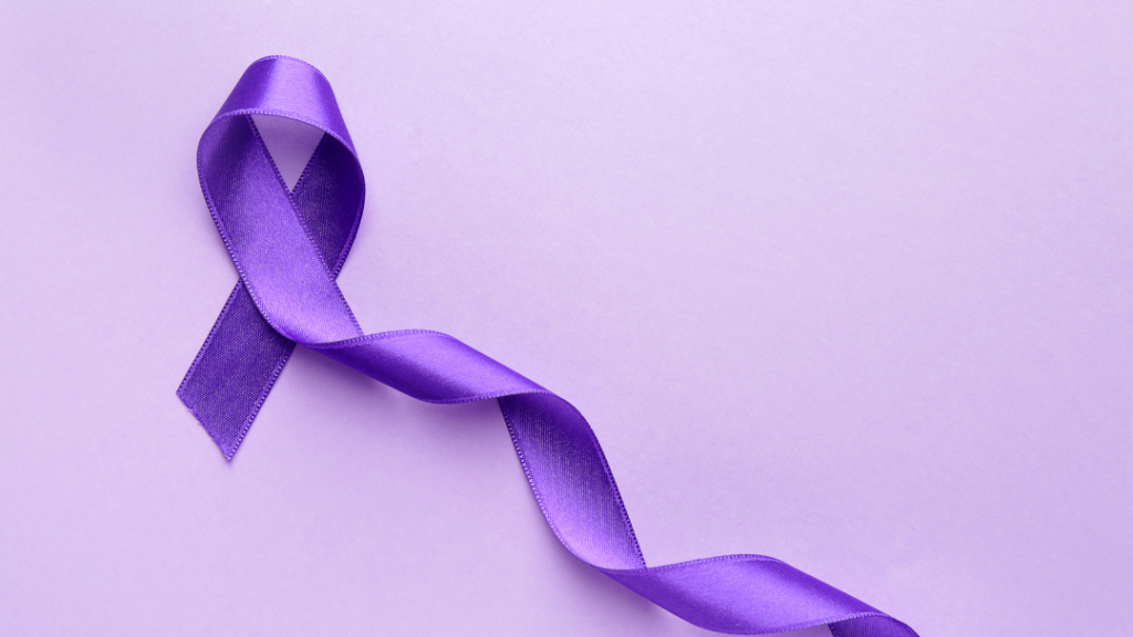 Purple satin awareness ribbon arranged in a loop on a lavender background conveying support or awareness